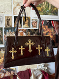 The charm of the crypt handbag